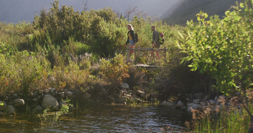 Hikers Enjoying Nature Walk Beside Riverside in Mountain Area - Free Images, Stock Photos and Pictures on Pikwizard.com