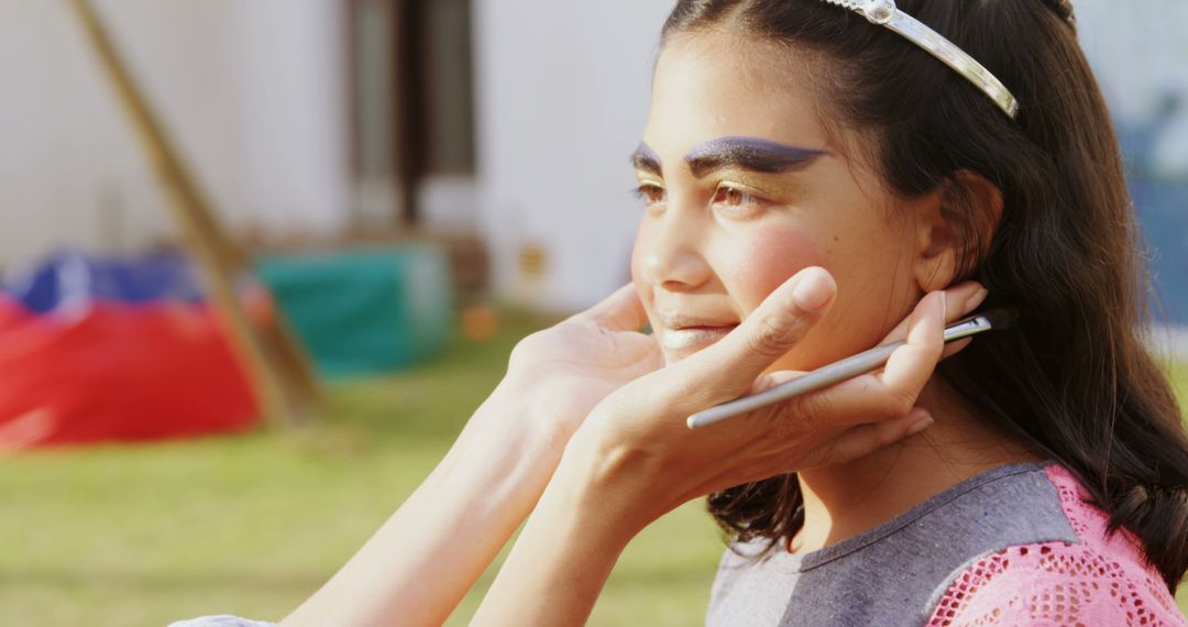 Female Makeup Artist Applying Blue Eyeshadow on Teenage Girl Outdoors - Free Images, Stock Photos and Pictures on Pikwizard.com