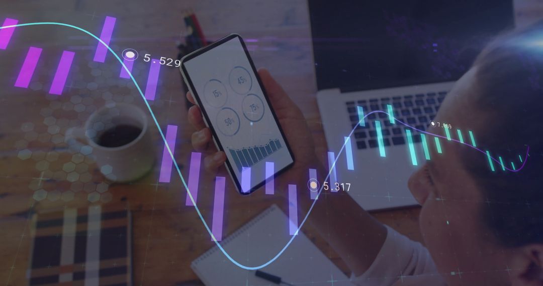 Analyst Using Smartphone for Data Analysis at Modern Workspace