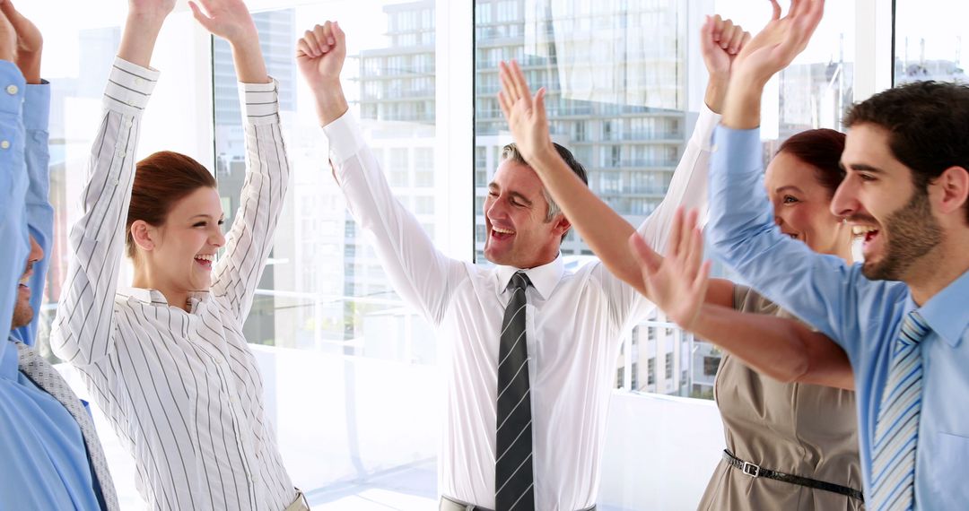 Cheerful Business Team Celebrating Success in Bright Office