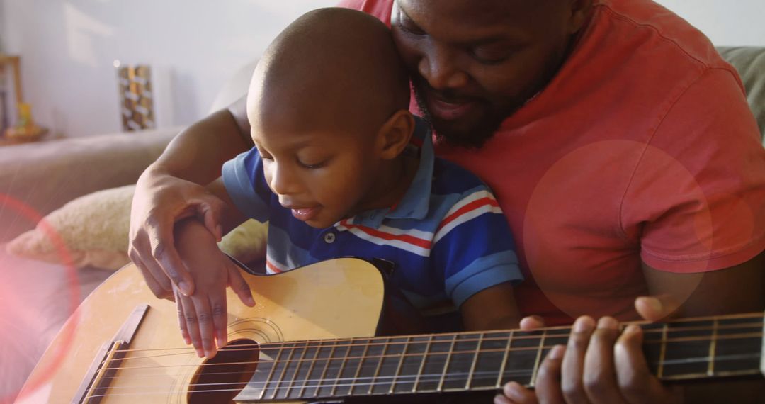 Father and Son Bonding Over Guitar Playing at Home - Free Images, Stock Photos and Pictures on Pikwizard.com