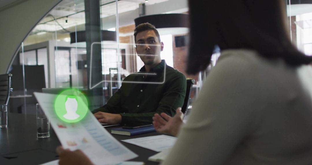 Recruiter reviewing resume with digital profile overlay in glass boardroom