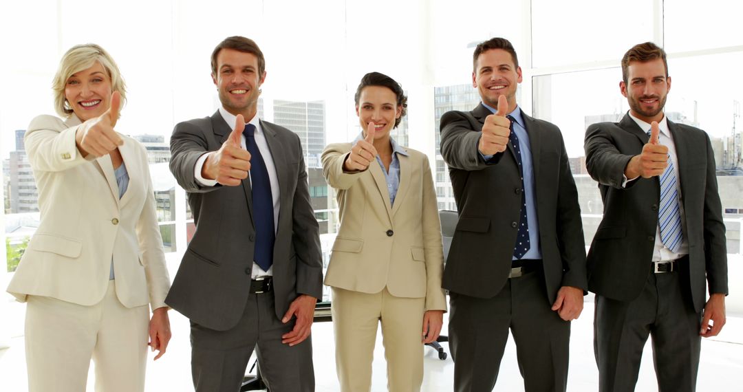 Business people giving thumbs up in the office - Free Images, Stock Photos and Pictures on Pikwizard.com