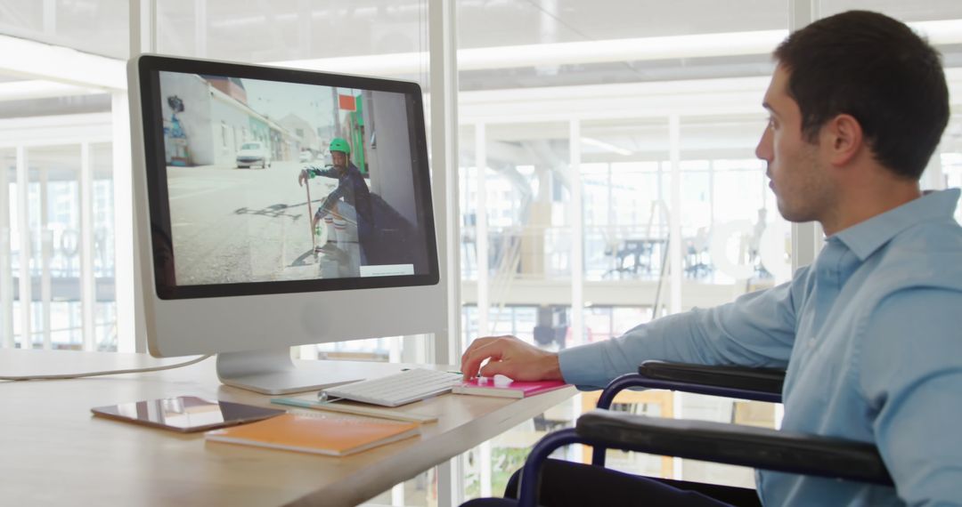Man Using Wheelchair Working on Office Computer