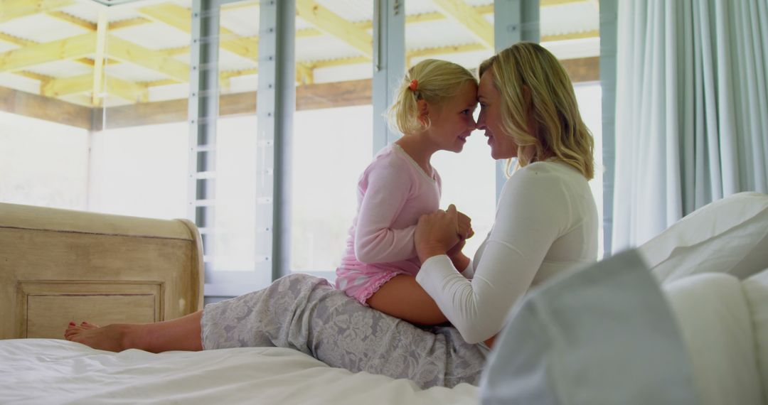 Mother and Daughter Sharing an Intimate Moment on a Bed - Free Images, Stock Photos and Pictures on Pikwizard.com