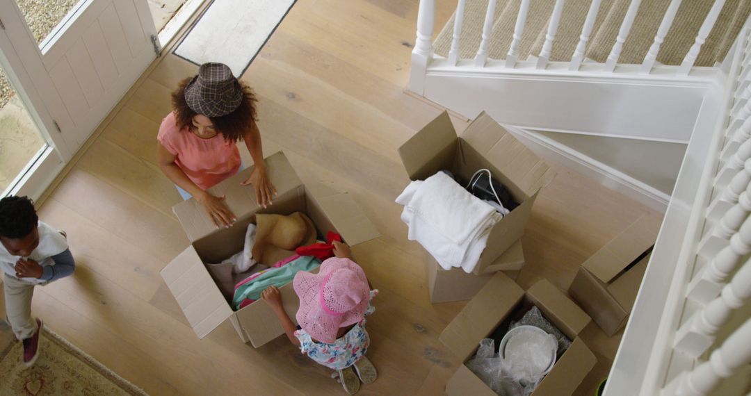 Family Unpacking Together On Moving Day - Free Images, Stock Photos and Pictures on Pikwizard.com