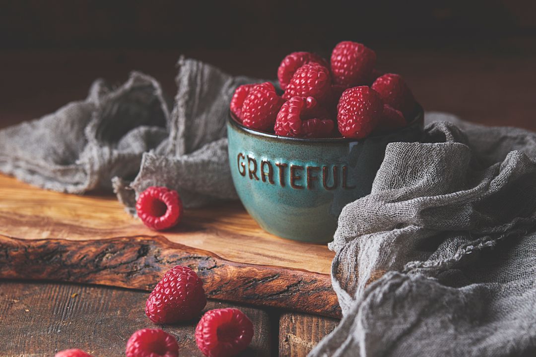 Rustic Gratitude Bowl Overflowing with Fresh Raspberries on Olive Wood Board with Linen