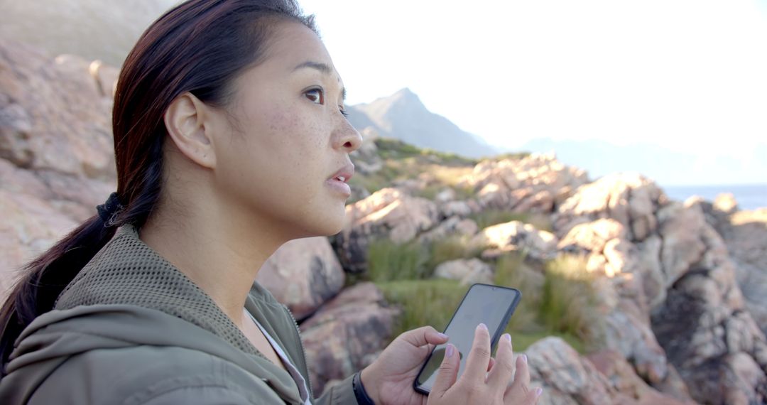 Woman Using Smartphone for Navigation in Rocky Mountains