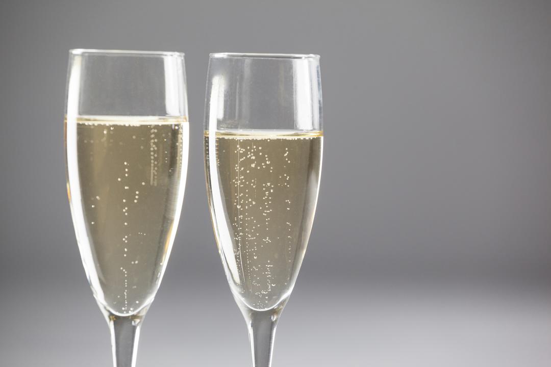 Two champagne flutes on white background - Free Images, Stock Photos and Pictures on Pikwizard.com