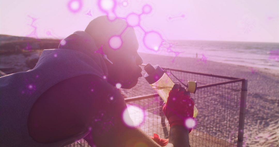 Athletic Man Drinking Water by the Beach with Digital Overlay
