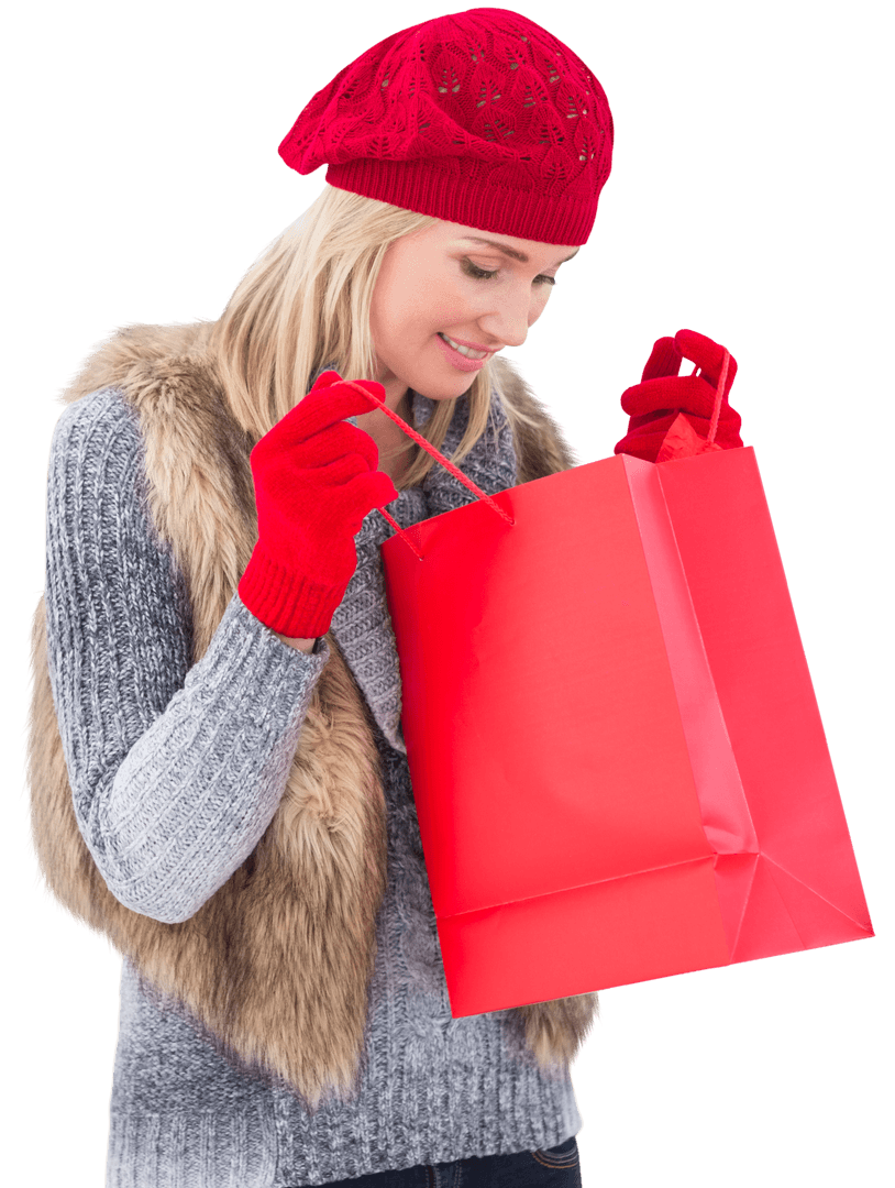 Woman in Winter Attire Looking into Red Shopping Bag Transparent Background