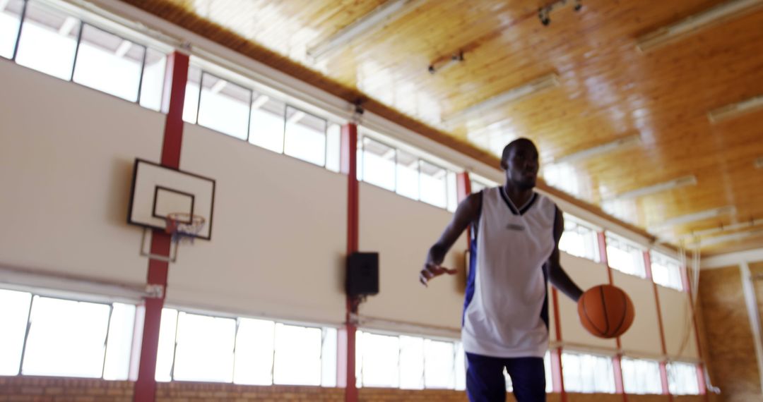 Focused Basketball Player Practicing Shooting Indoors