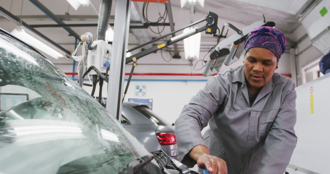 Female Mechanic Cleaning Windshield in Auto Repair Shop - Free Images, Stock Photos and Pictures on Pikwizard.com