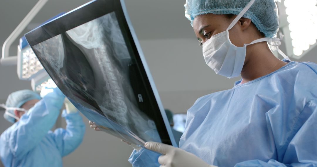 Female Surgeon Examining X-Ray During Surgery - Free Images, Stock Photos and Pictures on Pikwizard.com