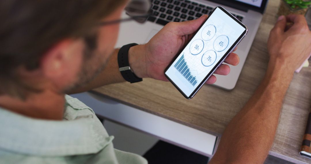 Businessman Analyzing Statistics on Smartphone Display