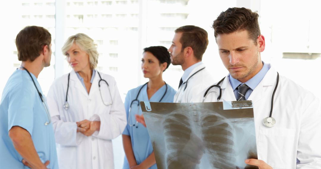 Medical Professionals Discussing X-ray Diagnosis - Free Images, Stock Photos and Pictures on Pikwizard.com