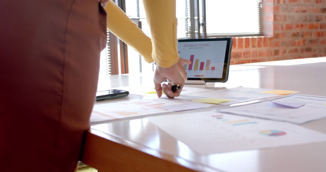 Person Analyzing Business Charts on Tablet at Office Desk - Free Images, Stock Photos and Pictures on Pikwizard.com