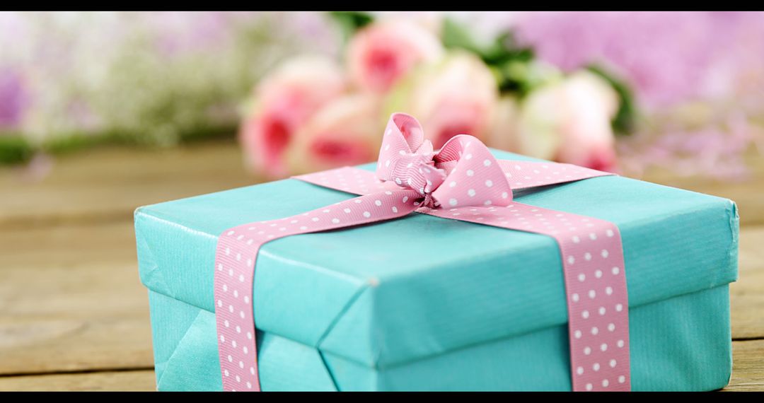 Beautifully Wrapped Gift Box With Pink Ribbon In Floral Background - Free Images, Stock Photos and Pictures on Pikwizard.com