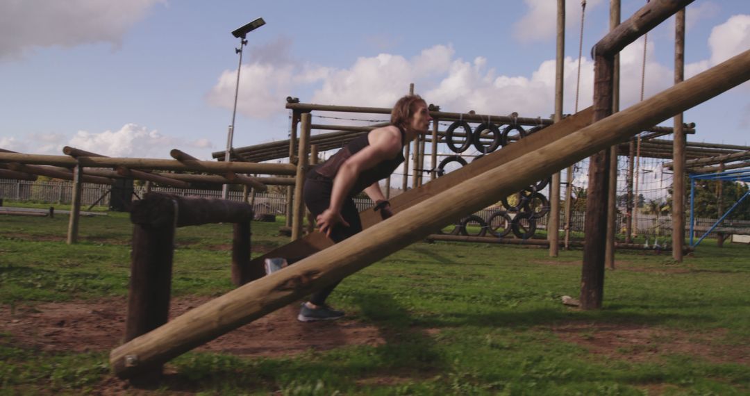 Woman Climbing Wooden Obstacle at Outdoor Training Course - Free Images, Stock Photos and Pictures on Pikwizard.com