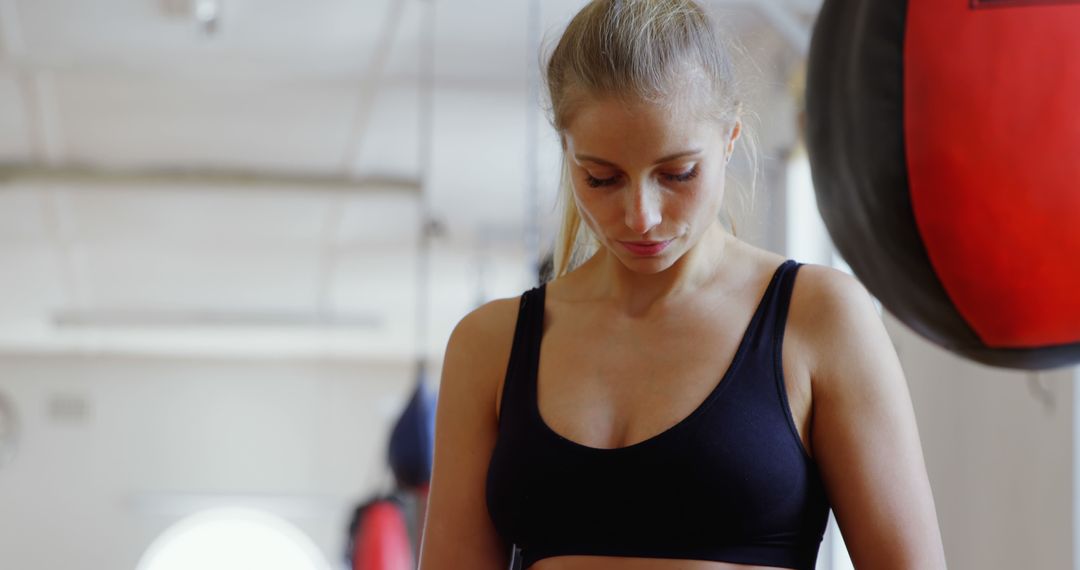 Determined Female Boxing Athlete Preparing for Training in Gym - Free Images, Stock Photos and Pictures on Pikwizard.com