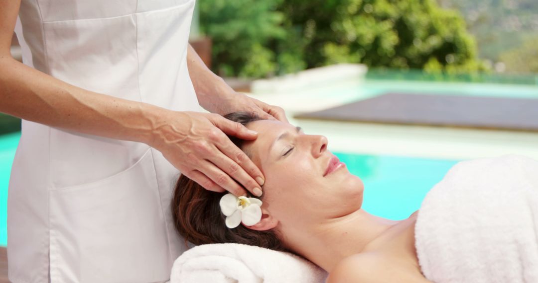 Relaxed Woman Receiving Head Massage at Poolside Spa - Free Images, Stock Photos and Pictures on Pikwizard.com