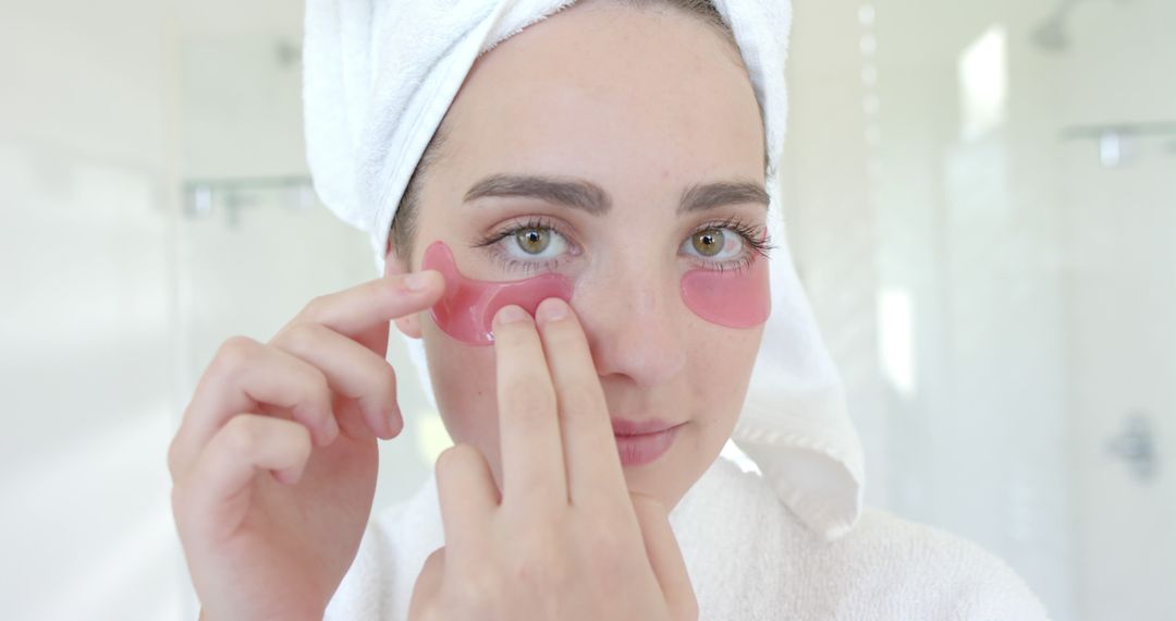 Woman Applying Under-Eye Patches in Bright Bathroom - Free Images, Stock Photos and Pictures on Pikwizard.com