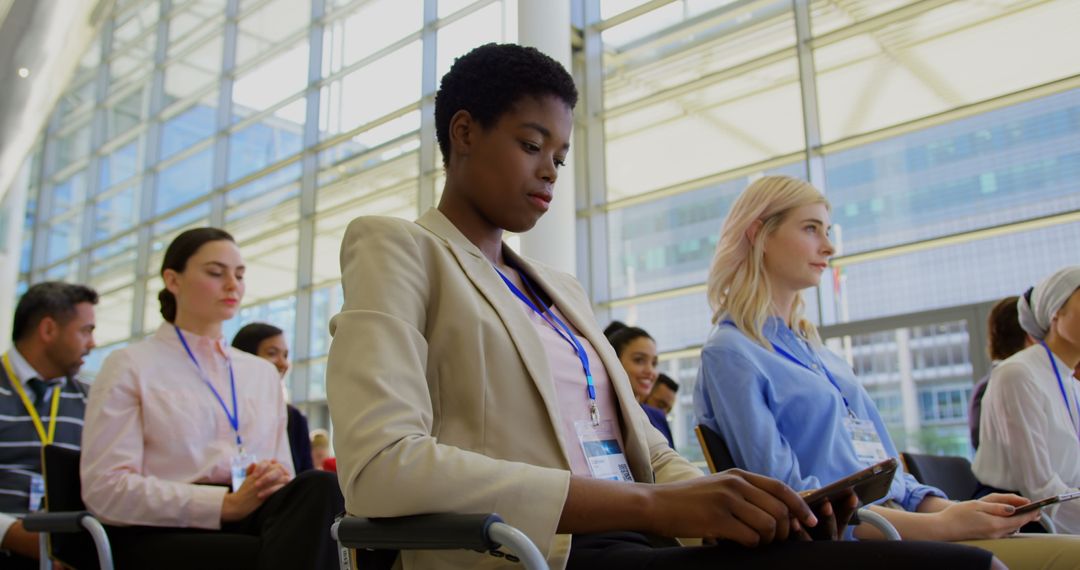 Diverse Professional Audience in Business Seminar with Digital Devices