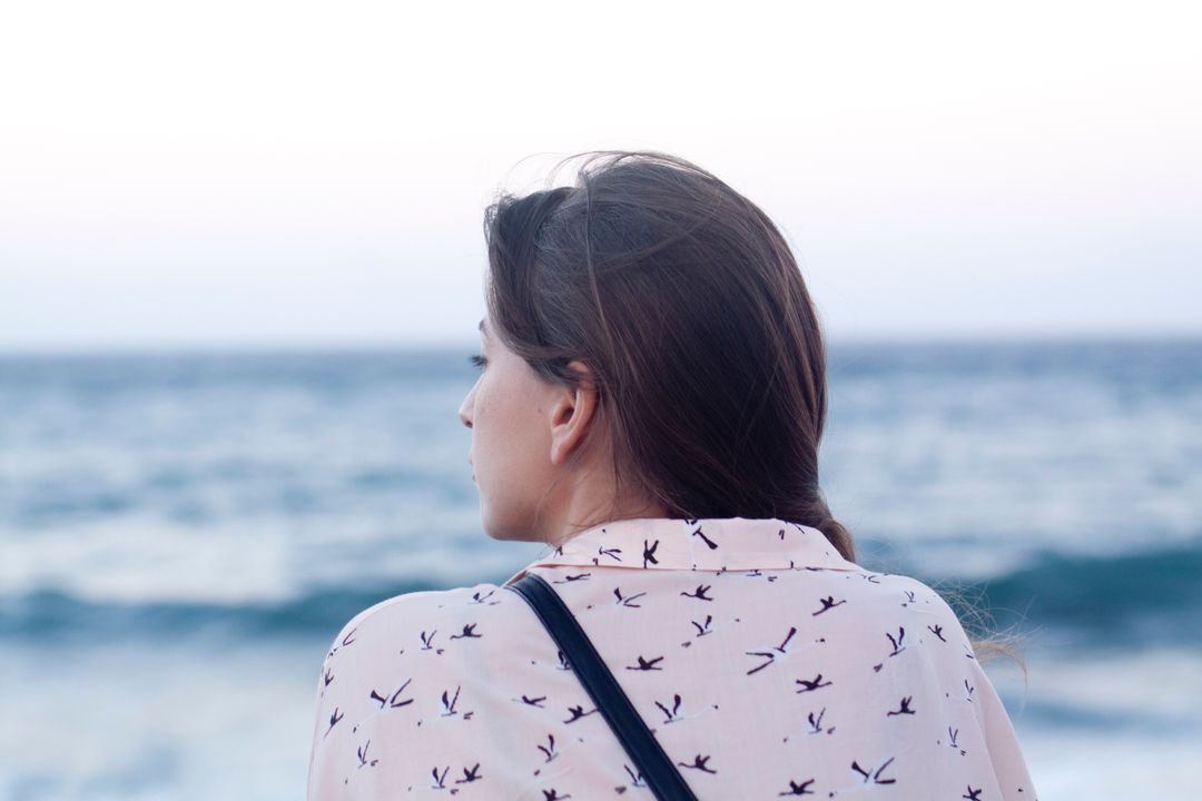 Woman Gazing at Ocean Horizon in Thoughtful Moment - Free Images, Stock Photos and Pictures on Pikwizard.com