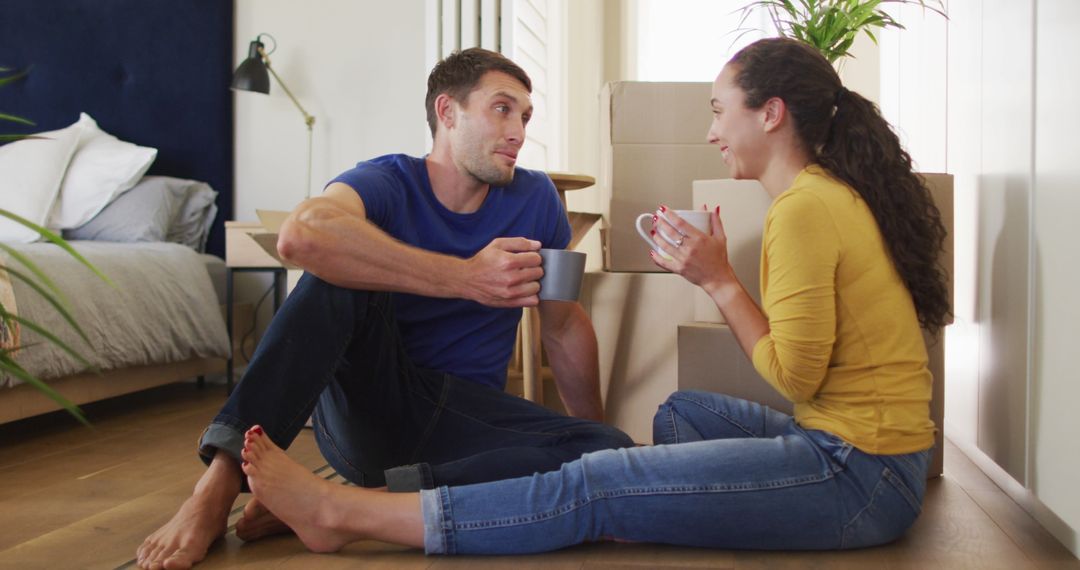 Couple Relaxing Together with Coffee After Moving Into New Home