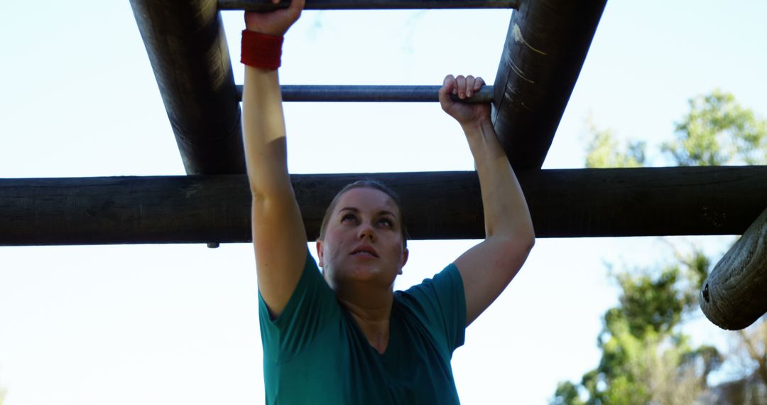 Determined Woman Navigating Monkey Bars in Outdoor Obstacle Course - Free Images, Stock Photos and Pictures on Pikwizard.com