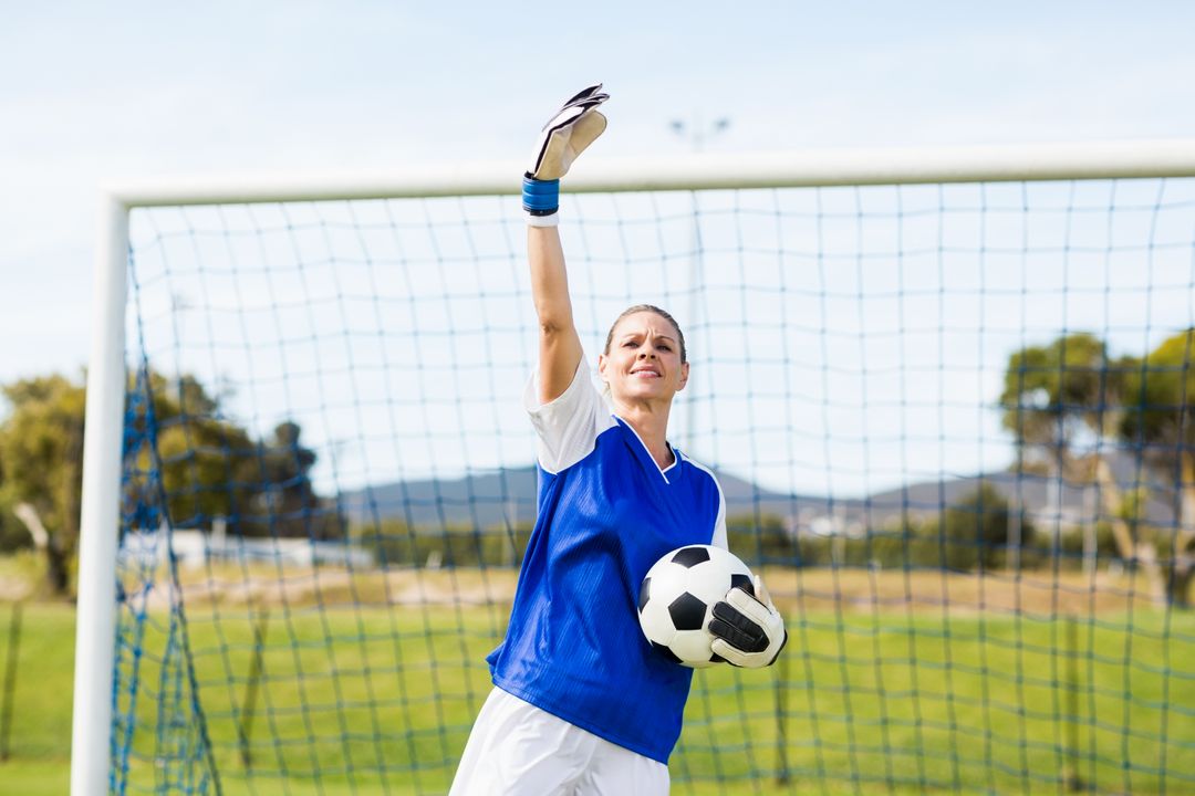 Female Goalkeeper Holding Soccer Ball and Gesturing on Field - Free Images, Stock Photos and Pictures on Pikwizard.com
