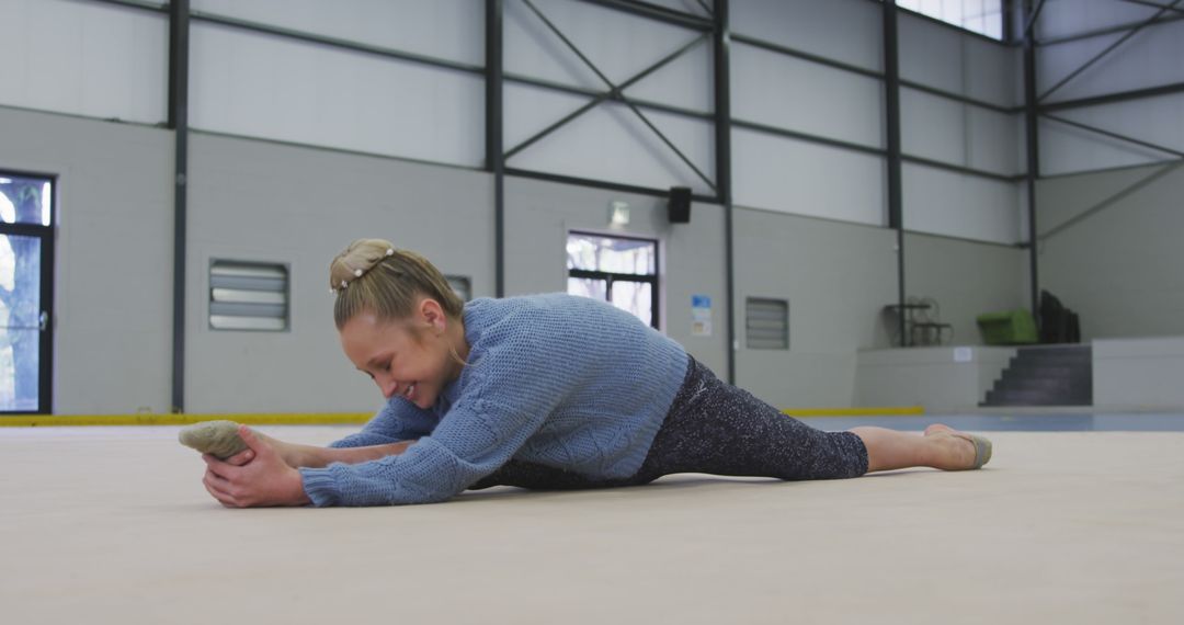 Young Woman Stretching on Floor in Gymnasium for Warm-Up - Free Images, Stock Photos and Pictures on Pikwizard.com