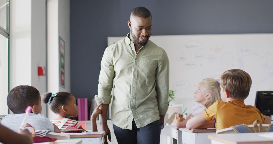 Image of happy african american male teacher during lesson with class of diverse pupils - Free Images, Stock Photos and Pictures on Pikwizard.com