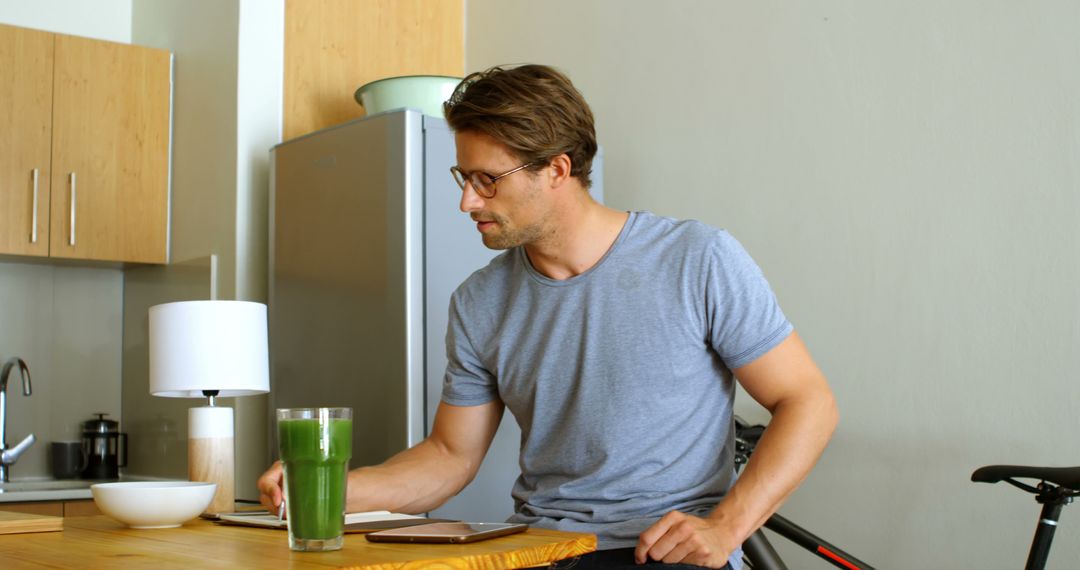 Man with Green Smoothie in Modern Kitchen Setting - Free Images, Stock Photos and Pictures on Pikwizard.com