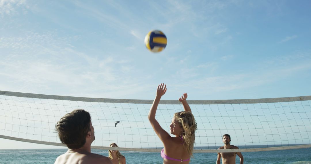 Group of Friends Playing Beach Volleyball in Bright Sunlight - Free Images, Stock Photos and Pictures on Pikwizard.com