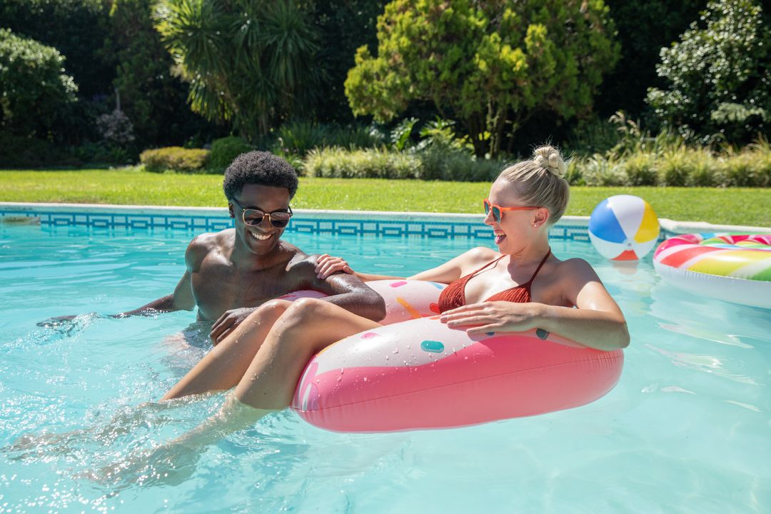Couple Enjoying Sunny Day in Backyard Pool with Inflatable Float