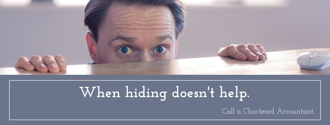 Man Peeking Over Desk Implies Urgency of Financial Advice