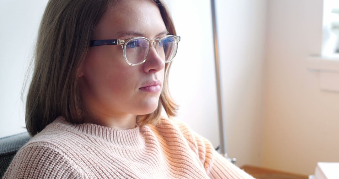 Young Woman Wearing Glasses Focused on Work Indoors - Free Images, Stock Photos and Pictures on Pikwizard.com