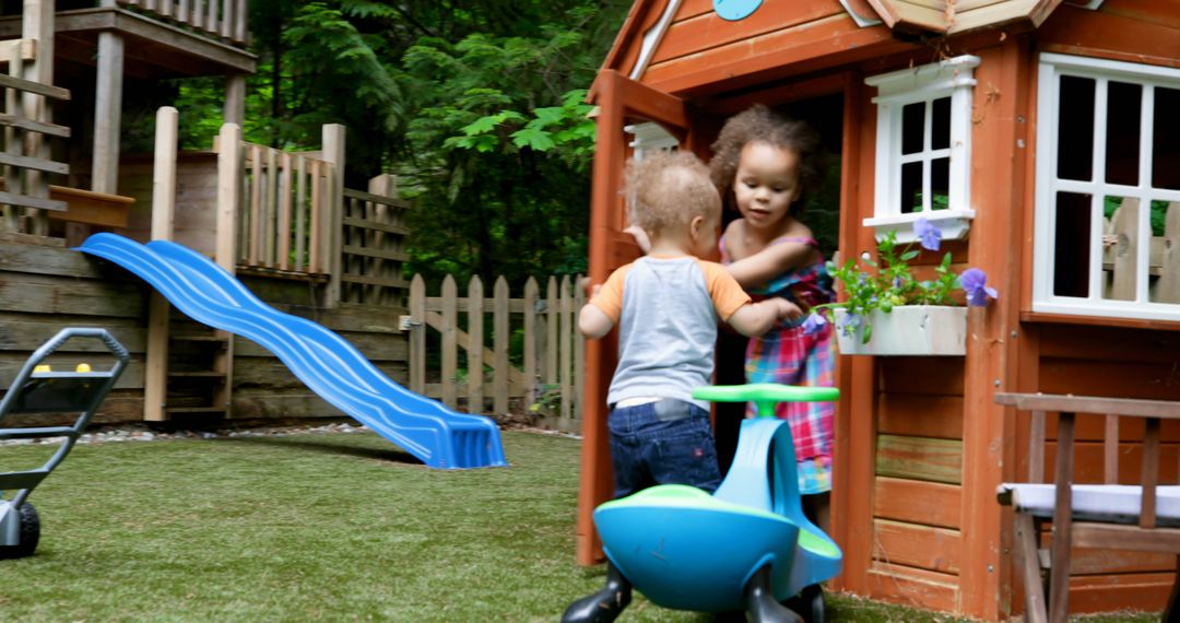 Children Playing in Backyard with Small Playhouse and Slide - Free Images, Stock Photos and Pictures on Pikwizard.com