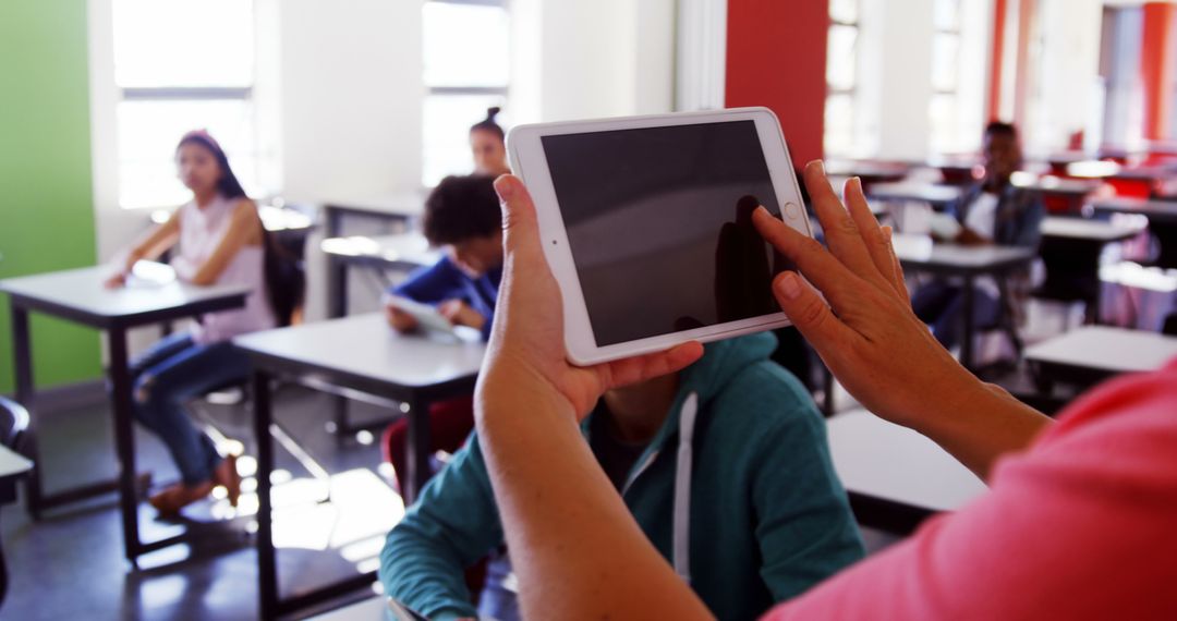 Teacher Using Tablet in Classroom with Students - Free Images, Stock Photos and Pictures on Pikwizard.com