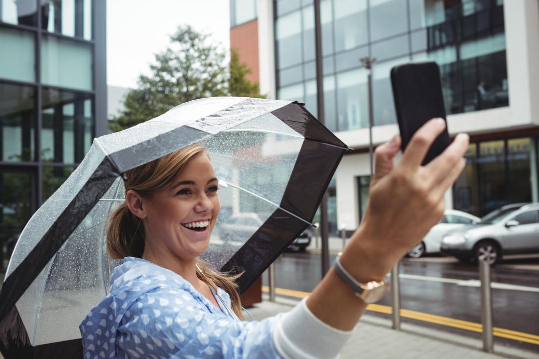 Image of a woman holding an umbrella and taking a picture of herself - Where to get great social media cover images - Image