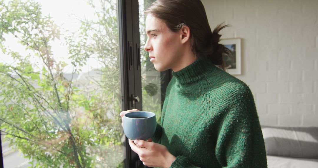 Pensive Woman Holding Coffee Looking Out Window On Calm Morning - Free Images, Stock Photos and Pictures on Pikwizard.com