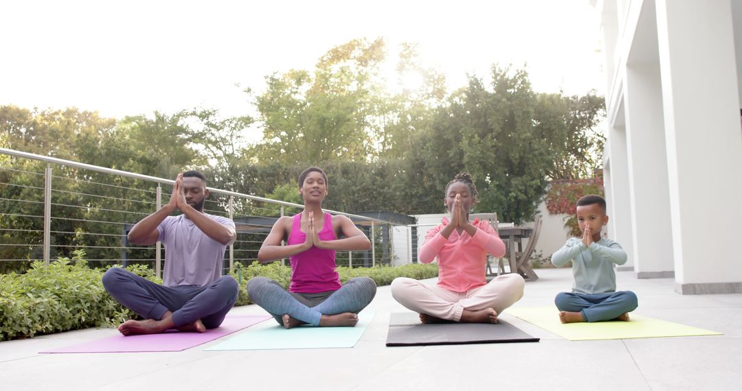 Happy African American Family Meditating Outdoors During Sunrise Yoga - Free Images, Stock Photos and Pictures on Pikwizard.com