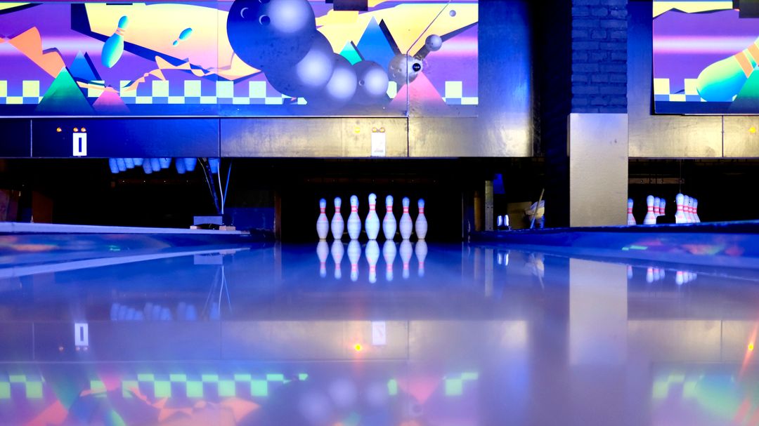 Empty Bowling Alley with Colorful Screen and Pins
