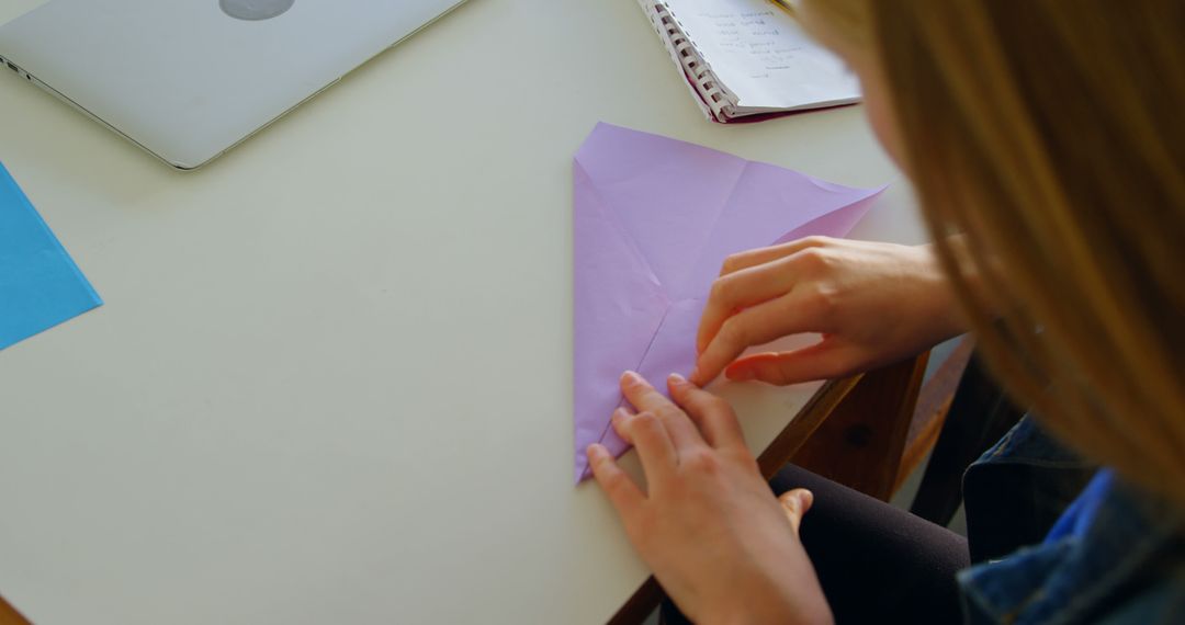 Person Folding Origami Paper at Home on Desk - Free Images, Stock Photos and Pictures on Pikwizard.com