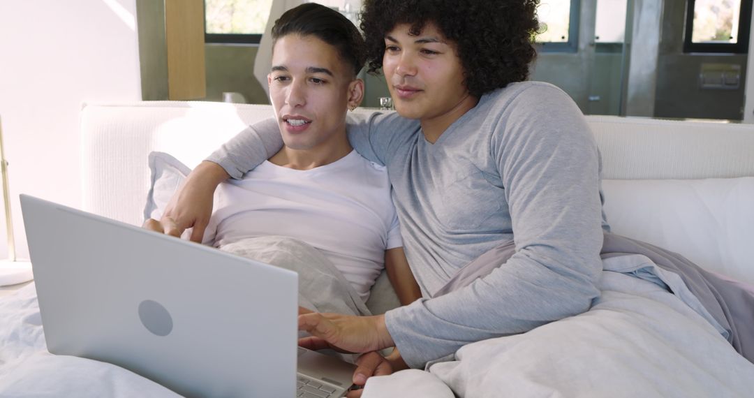 Couple Relaxing in Bed with Laptop, Sharing Intimate Moment