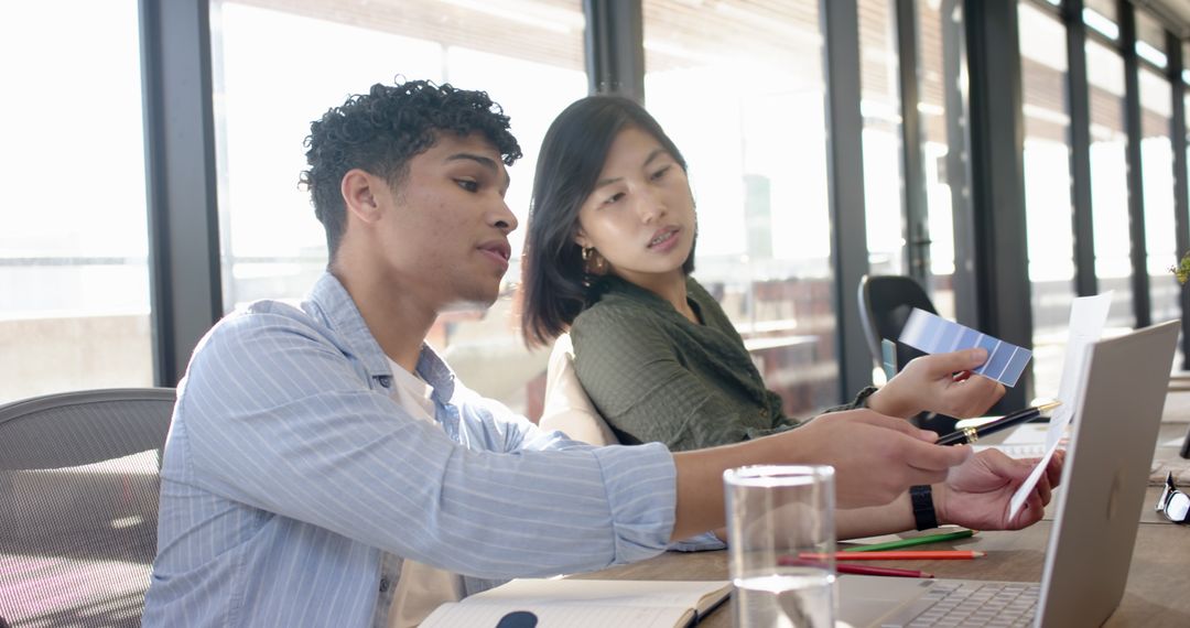 Diverse Coworkers Collaborating on Color Palette and Designs