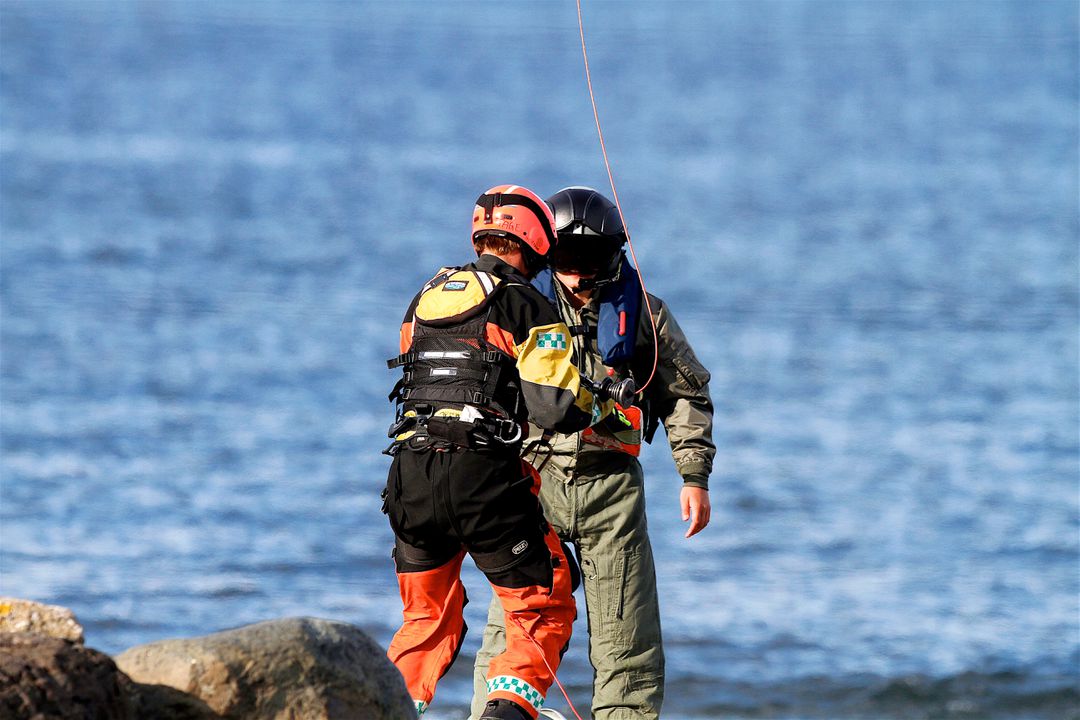 Rescue Workers Assisting Individual During Water Rescue Operation - Free Images, Stock Photos and Pictures on Pikwizard.com