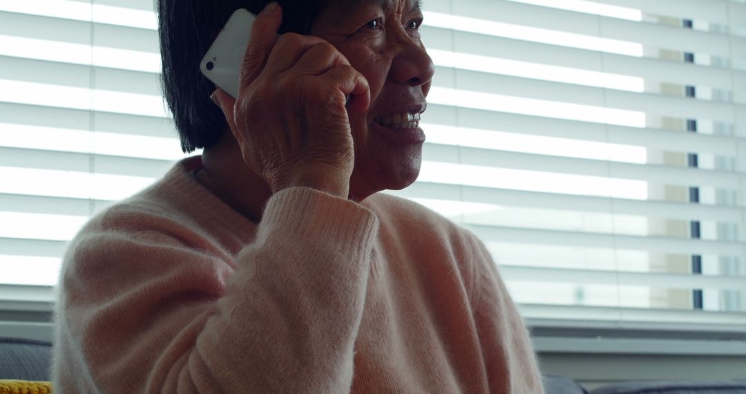 Elderly Woman Talking on Phone by Window - Free Images, Stock Photos and Pictures on Pikwizard.com