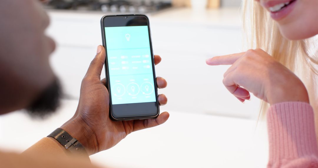 Friends Using Smartphone to Control Smart Home in Kitchen